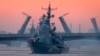 RUSSIA -- A warship floats past drawbridges rising above the Neva River during preparations for the Naval parade in St. Petersburg, July 20, 2020